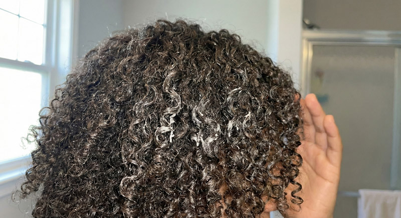 Product buildup sitting on low porosity hair not absorbing