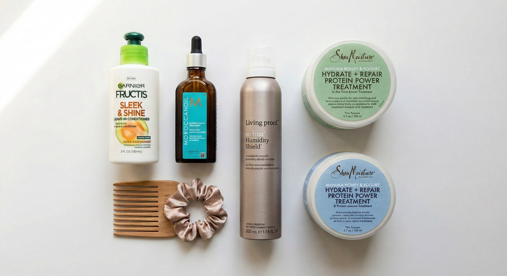 Essential hair products for fighting frizz including leave-in conditioner, hair oil, and deep conditioning mask